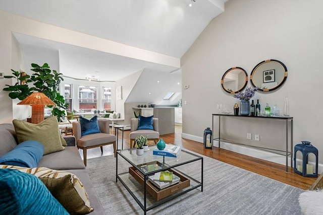 living room featuring lofted ceiling and hardwood / wood-style flooring