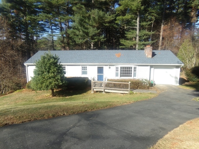 ranch-style house with a garage and a front yard