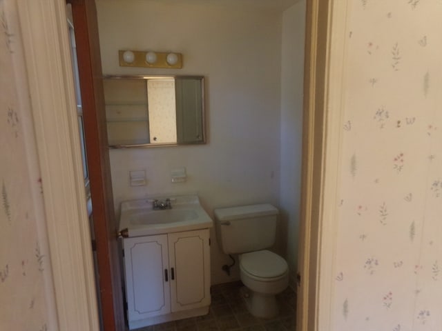 bathroom with toilet and vanity