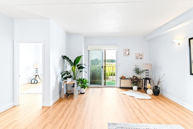 200 Cove Way Unit 106, Quincy, MA 02169 - sitting room with wood finished floors and baseboards