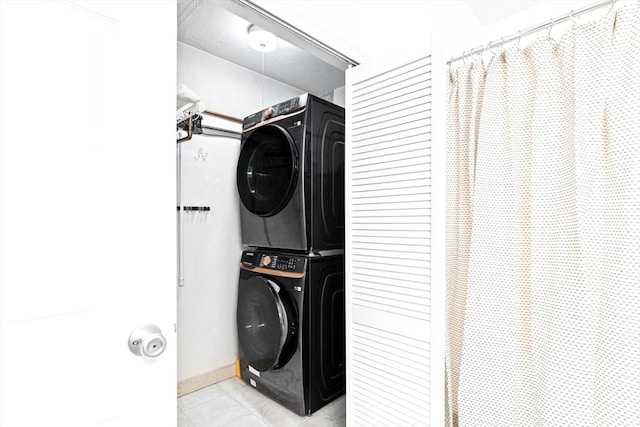 200 Cove Way Unit 106, Quincy, MA 02169 - laundry room featuring estacked washer and dryer and light tile patterned floors