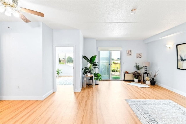 200 Cove Way Unit 106, Quincy, MA 02169 - living area featuring light wood-style floors, ceiling fan, and a textured ceiling