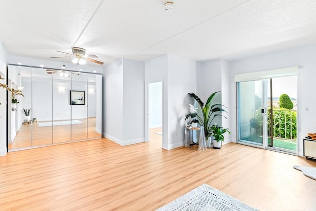 200 Cove Way Unit 106, Quincy, MA 02169 - living area featuring ceiling fan, light wood-style flooring, and a textured ceiling