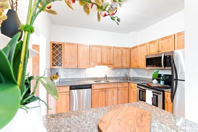 200 Cove Way Unit 106, Quincy, MA 02169 - kitchen featuring stainless steel appliances, light brown cabinetry, light stone counters, and decorative backsplash