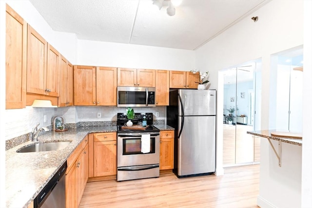 200 Cove Way Unit 106, Quincy, MA 02169 - kitchen featuring stainless steel appliances, light wood finished floors, stone counters, and tasteful backsplash