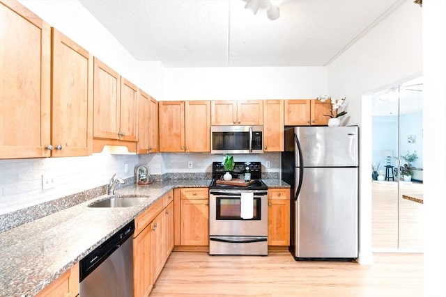 200 Cove Way Unit 106, Quincy, MA 02169 - kitchen with stainless steel appliances, light brown cabinetry, light wood-style flooring, stone countertops, and backsplash