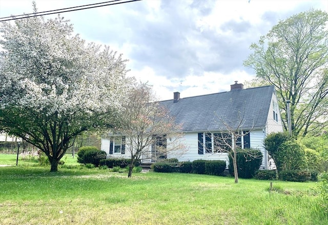 52 Burnett St, Granby, MA 01033 - view of front of property with a front yard, a chimney, and a shingled roof