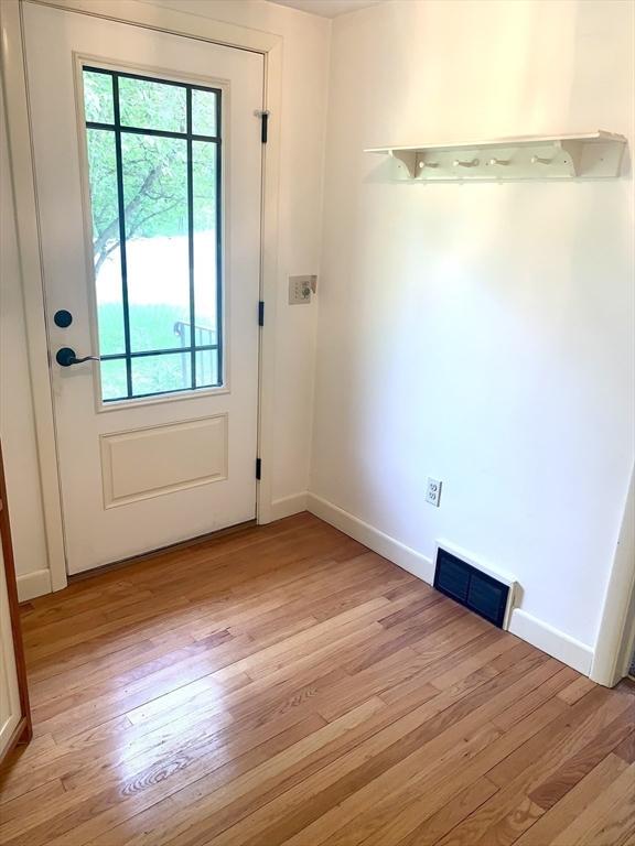 52 Burnett St, Granby, MA 01033 - doorway featuring light wood finished floors and baseboards