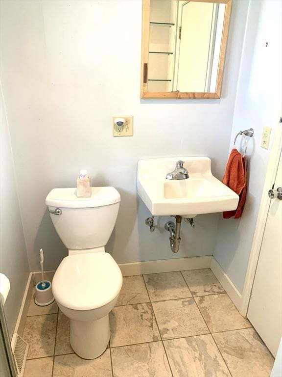 52 Burnett St, Granby, MA 01033 - half bathroom featuring baseboards, toilet, and a sink