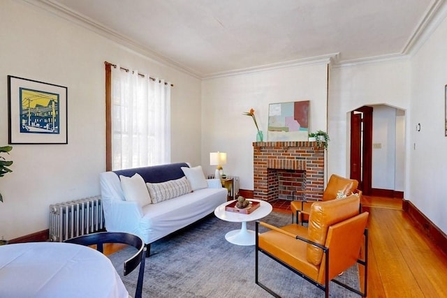 140 Highland Ave Unit 1, Somerville, MA 02143 - living area with ornamental molding, wood finished floors, radiator, a fireplace, and baseboards