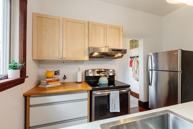 140 Highland Ave Unit 1, Somerville, MA 02143 - kitchen featuring under cabinet range hood, stainless steel appliances, and light brown cabinetry