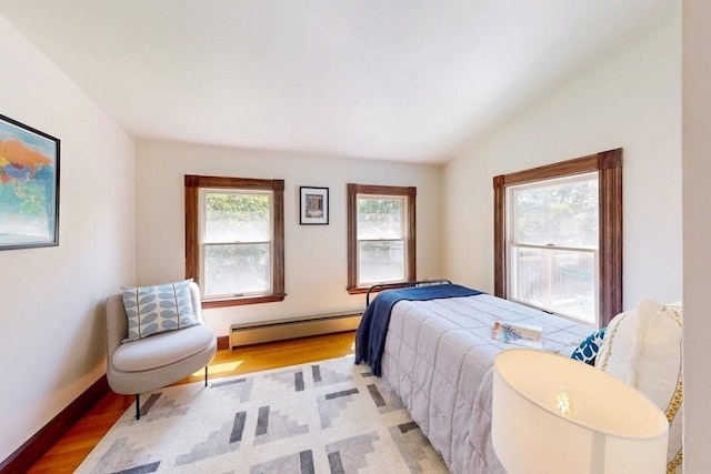 140 Highland Ave Unit 1, Somerville, MA 02143 - bedroom with a baseboard radiator, light wood-type flooring, and vaulted ceiling