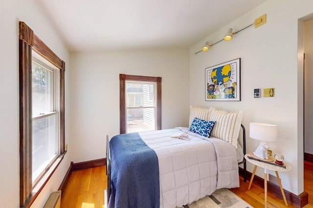 140 Highland Ave Unit 1, Somerville, MA 02143 - bedroom with multiple windows, light wood-style flooring, and baseboards