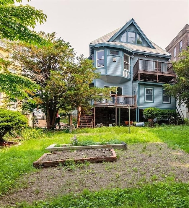 140 Highland Ave Unit 1, Somerville, MA 02143 - rear view of house featuring a deck, a vegetable garden, and stairs
