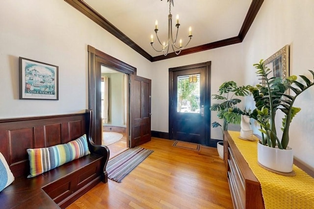 140 Highland Ave Unit 1, Somerville, MA 02143 - foyer entrance with ornamental molding, a chandelier, and light wood-style flooring