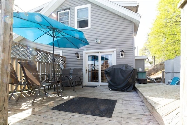 deck with area for grilling and fence