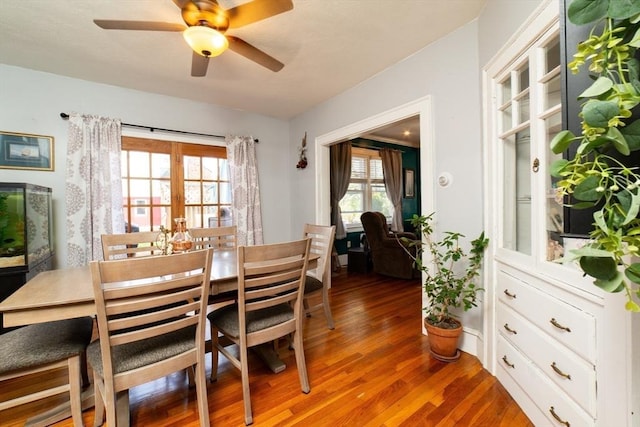 dining space featuring ceiling fan and wood finished floors