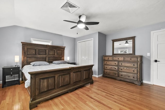 bedroom featuring visible vents, baseboards, light wood-style floors, and a closet