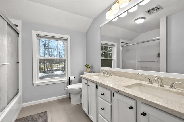 bathroom featuring a sink, visible vents, toilet, and vaulted ceiling