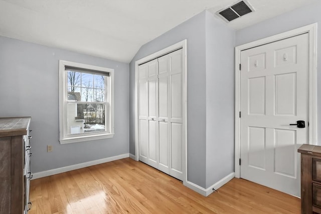 unfurnished bedroom featuring visible vents, baseboards, and light wood-style floors