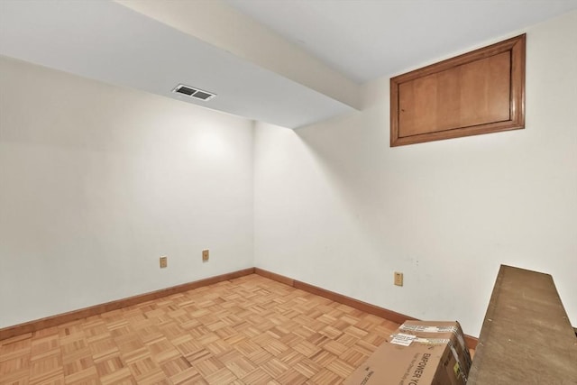 unfurnished room with visible vents and baseboards