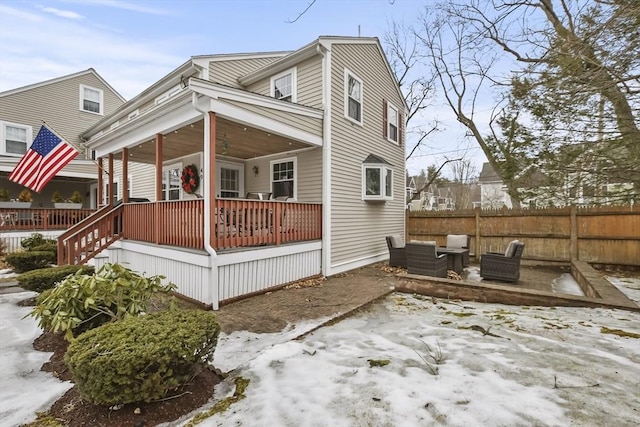 exterior space featuring a porch, fence, and an outdoor living space