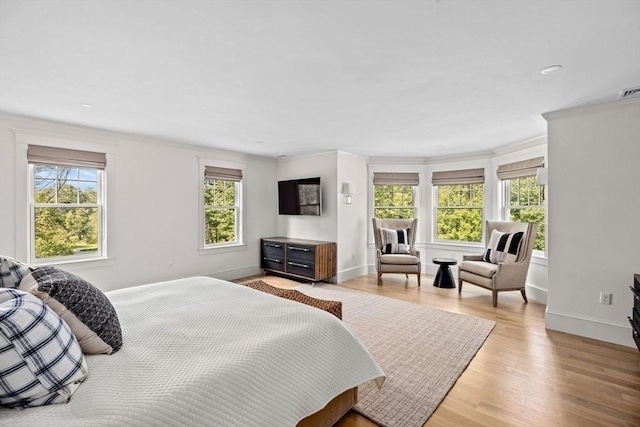 bedroom featuring recessed lighting, baseboards, ornamental molding, and light wood-type flooring