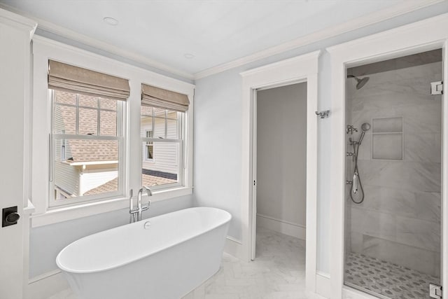 full bathroom featuring a freestanding bath, a stall shower, baseboards, marble finish floor, and ornamental molding