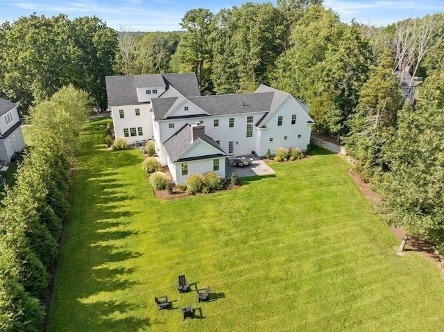 drone / aerial view with a wooded view