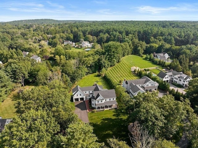 drone / aerial view featuring a wooded view