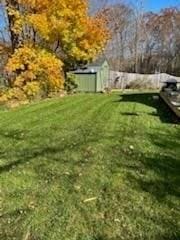 view of yard with a storage unit and an outbuilding