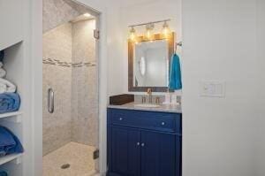 bathroom with vanity and a shower with shower door