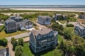 bird's eye view featuring a water view and a beach view