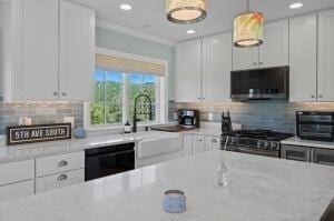 kitchen with range, white cabinets, and black dishwasher