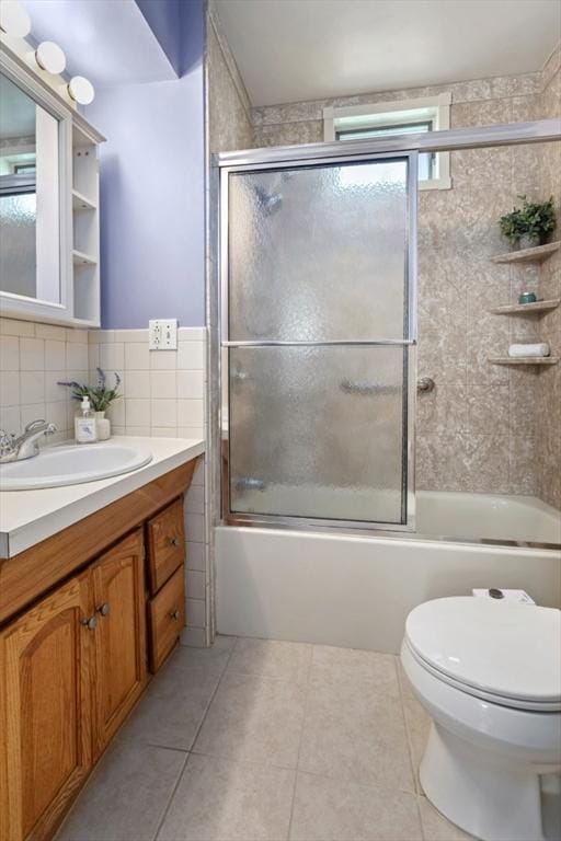 162 Park St Unit 1, Beverly, MA 01915 - full bath featuring vanity, tile patterned flooring, toilet, shower / bath combination with glass door, and tile walls
