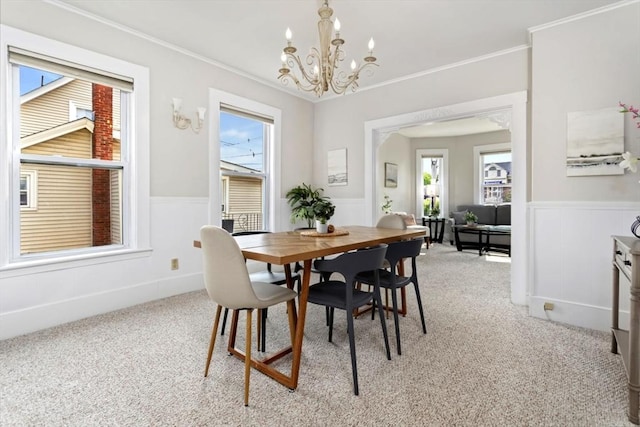 162 Park St Unit 1, Beverly, MA 01915 - dining area with a chandelier, plenty of natural light, light colored carpet, wainscoting, and crown molding