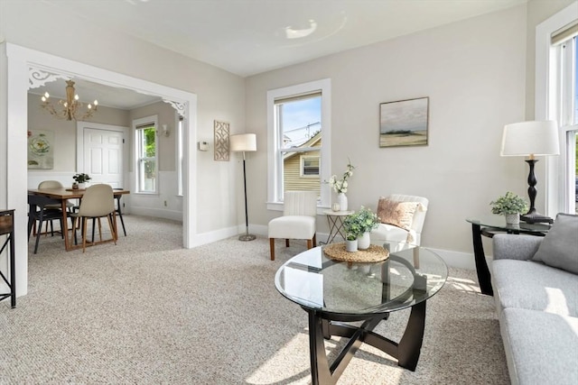 162 Park St Unit 1, Beverly, MA 01915 - living room featuring baseboards, a chandelier, and carpet