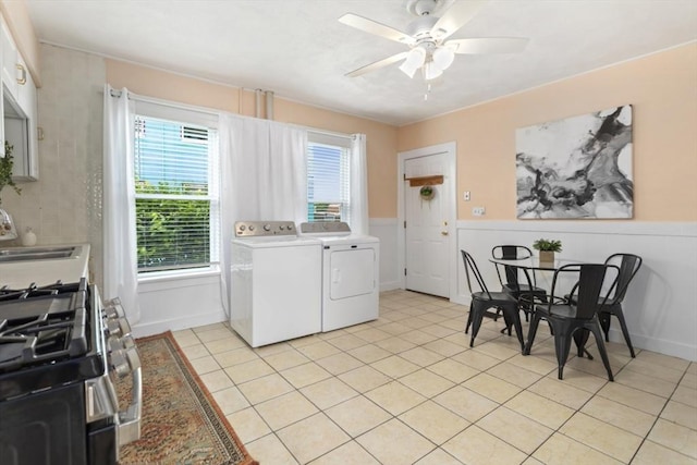 162 Park St Unit 1, Beverly, MA 01915 - laundry area with ceiling fan, wainscoting, washing machine and dryer, and light tile patterned flooring