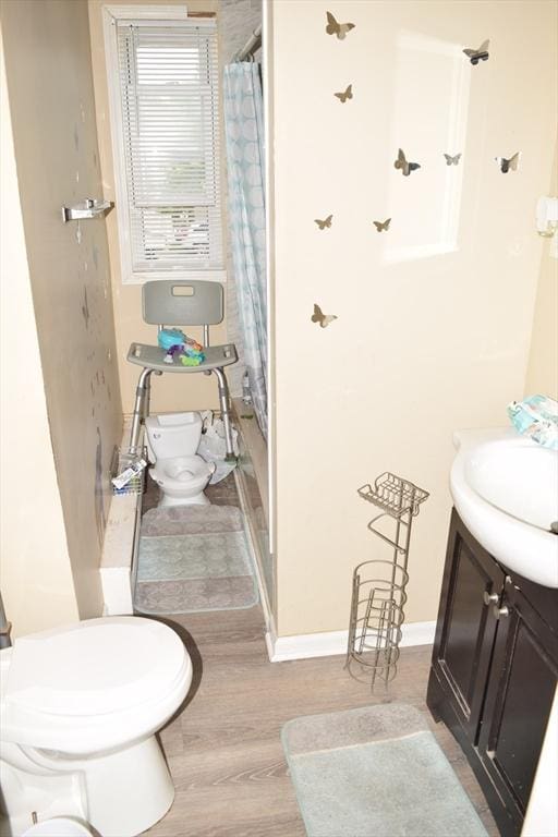 1407-1409 Worcester St, Springfield, MA 01151 - bathroom featuring toilet, vanity, wood finished floors, curtained shower, and baseboards
