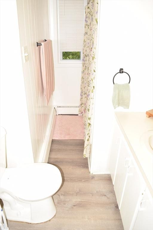 1407-1409 Worcester St, Springfield, MA 01151 - bathroom with a baseboard heating unit, vanity, wood finished floors, and toilet