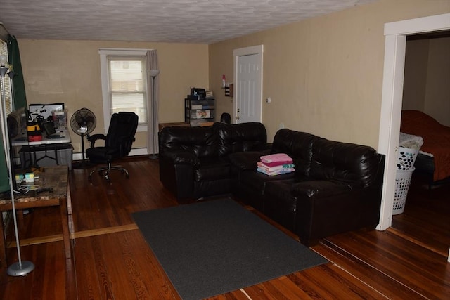 1407-1409 Worcester St, Springfield, MA 01151 - living room with wood finished floors, a textured ceiling, a desk, and baseboard heating