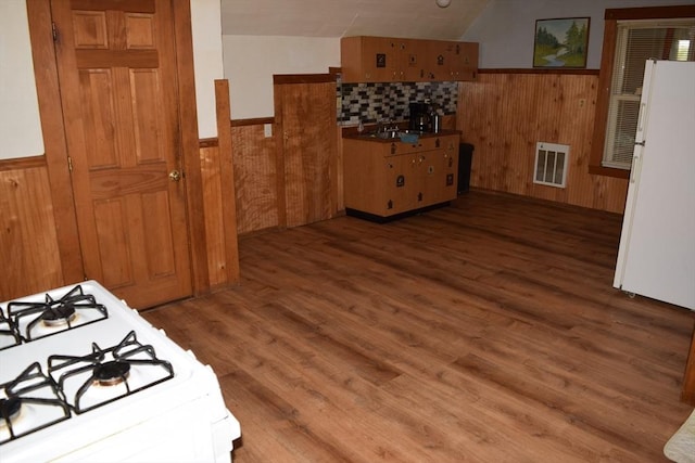 1407-1409 Worcester St, Springfield, MA 01151 - kitchen featuring white appliances, a wainscoted wall, a sink, wooden walls, and wood finished floors