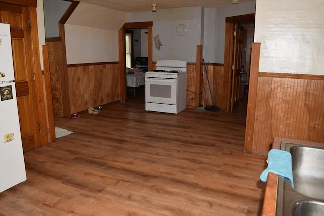 1407-1409 Worcester St, Springfield, MA 01151 - kitchen with white gas range oven, wood walls, a wainscoted wall, wood finished floors, and vaulted ceiling