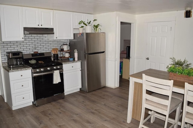 1407-1409 Worcester St, Springfield, MA 01151 - kitchen featuring stainless steel appliances, under cabinet range hood, white cabinetry, dark wood-style floors, and backsplash