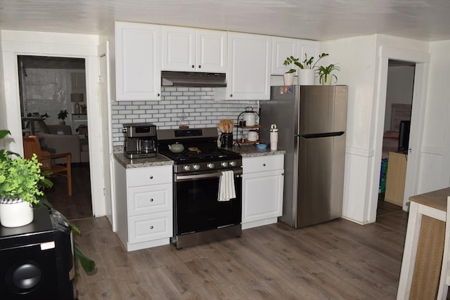1407-1409 Worcester St, Springfield, MA 01151 - kitchen with appliances with stainless steel finishes, under cabinet range hood, white cabinets, and dark wood-style flooring