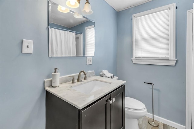 bathroom with vanity, toilet, curtained shower, and hardwood / wood-style floors