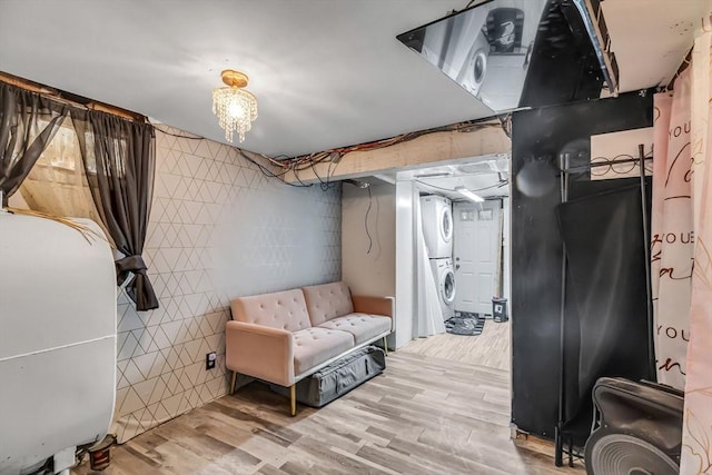 basement featuring stacked washer and dryer and light wood-type flooring