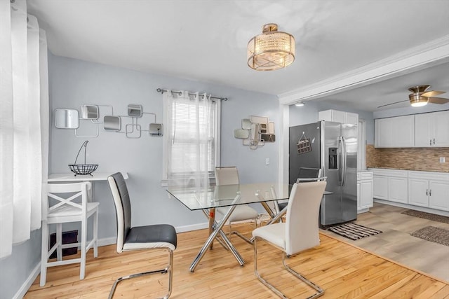 dining room with light hardwood / wood-style floors and ceiling fan