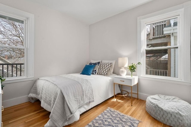 bedroom featuring baseboards and wood-type flooring