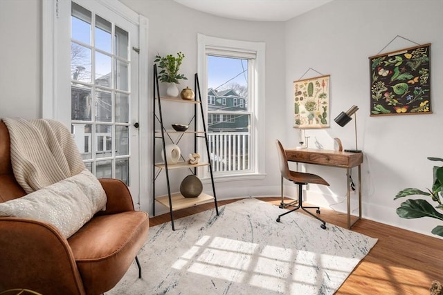 office space with baseboards and wood finished floors